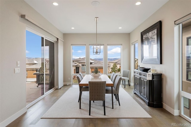 dining area with a chandelier and light hardwood / wood-style floors