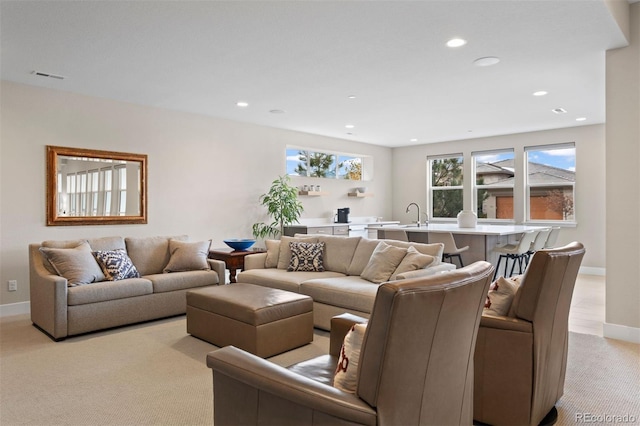 living room with sink and light carpet