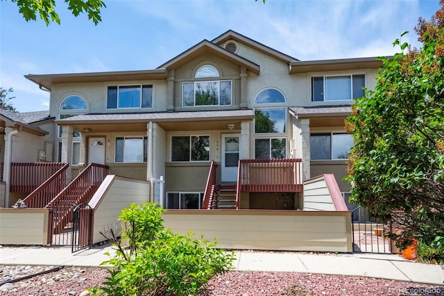 584 Ridgeview Dr, Louisville, CO 80027 - multi unit property featuring stucco siding, a fenced front yard, stairway, and a gate