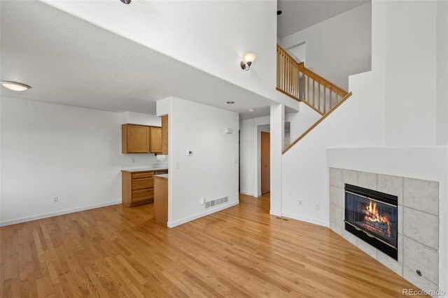 584 Ridgeview Dr, Louisville, CO 80027 - unfurnished living room with light wood finished floors, a fireplace, and baseboards