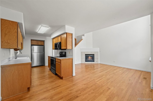 584 Ridgeview Dr, Louisville, CO 80027 - kitchen with freestanding refrigerator, electric range, a sink, and light wood-type flooring