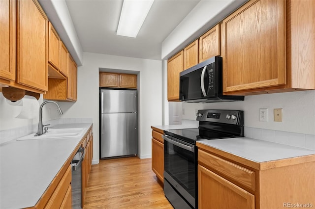 584 Ridgeview Dr, Louisville, CO 80027 - kitchen featuring stainless steel appliances, a sink, light countertops, and light wood-style flooring