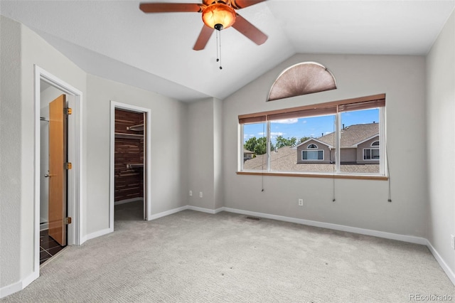 584 Ridgeview Dr, Louisville, CO 80027 - unfurnished bedroom featuring carpet, lofted ceiling, a spacious closet, and baseboards