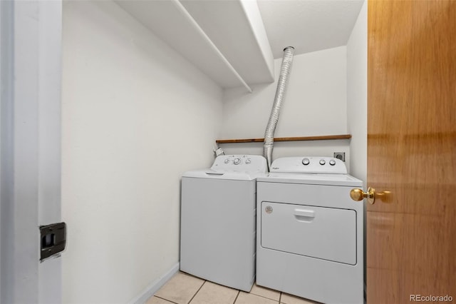 584 Ridgeview Dr, Louisville, CO 80027 - laundry room with separate washer and dryer, light tile patterned floors, and baseboards