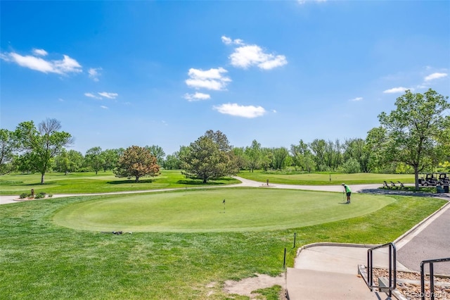 584 Ridgeview Dr, Louisville, CO 80027 - view of home's community with an area to practice putting, golf course view, a lawn, and view of scattered trees