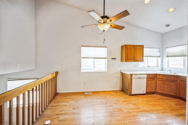 kitchen featuring light wood-type flooring, white dishwasher, a wealth of natural light, and lofted ceiling