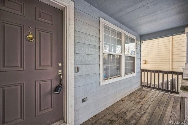 view of exterior entry with covered porch