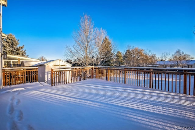 deck featuring an outdoor structure and a storage shed