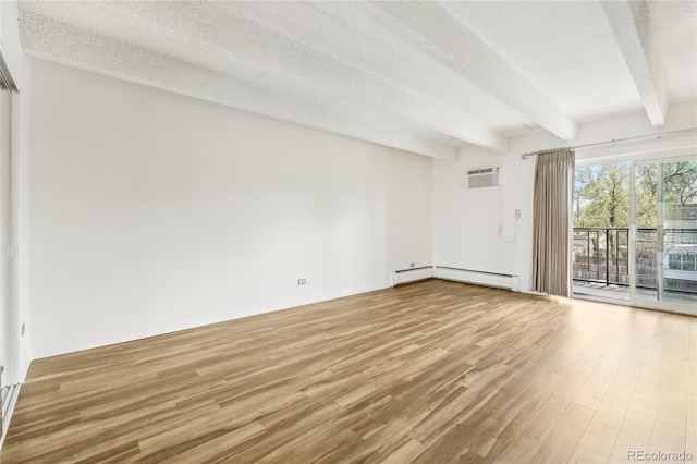 spare room with wood finished floors, beamed ceiling, baseboard heating, an AC wall unit, and a textured ceiling