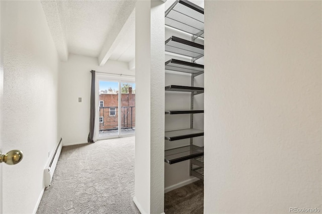 hall featuring carpet, baseboards, baseboard heating, and beam ceiling