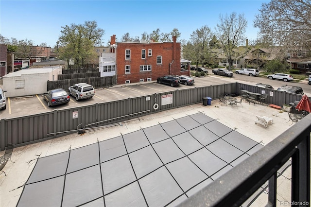 view of patio with fence and a residential view