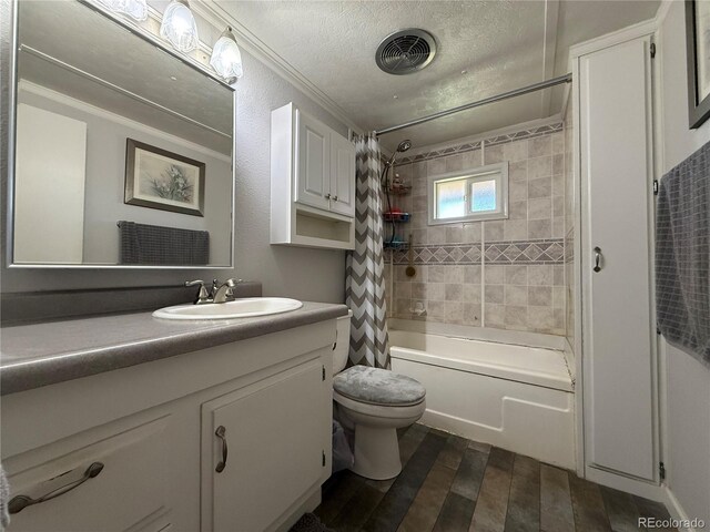 21300 County Road 13, La Jara, CO 81140 - full bath with a textured ceiling, toilet, shower / tub combo, wood finished floors, and vanity