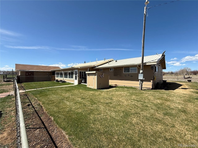 21300 County Road 13, La Jara, CO 81140 - back of house featuring metal roof, a yard, and fence