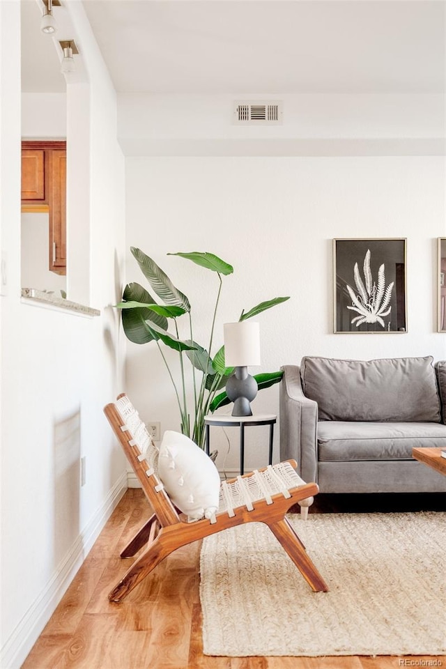 sitting room with wood-type flooring