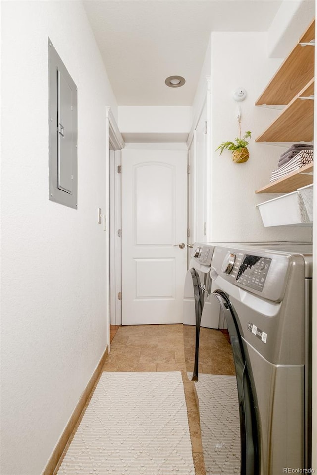 laundry area with electric panel and washer and clothes dryer