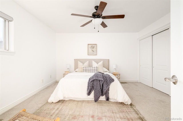 bedroom featuring light carpet, a closet, and ceiling fan