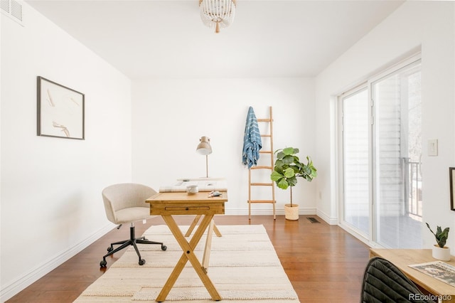 home office with wood-type flooring