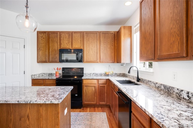 5861 Mt Shadows Blvd, Firestone, CO 80504 - kitchen with black appliances, a sink, light wood-style flooring, brown cabinets, and recessed lighting