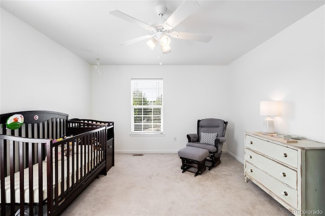 5861 Mt Shadows Blvd, Firestone, CO 80504 - bedroom with baseboards, a crib, light colored carpet, and ceiling fan