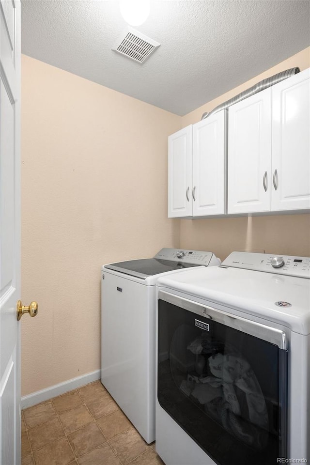 5861 Mt Shadows Blvd, Firestone, CO 80504 - laundry area featuring separate washer and dryer, cabinet space, and a textured ceiling
