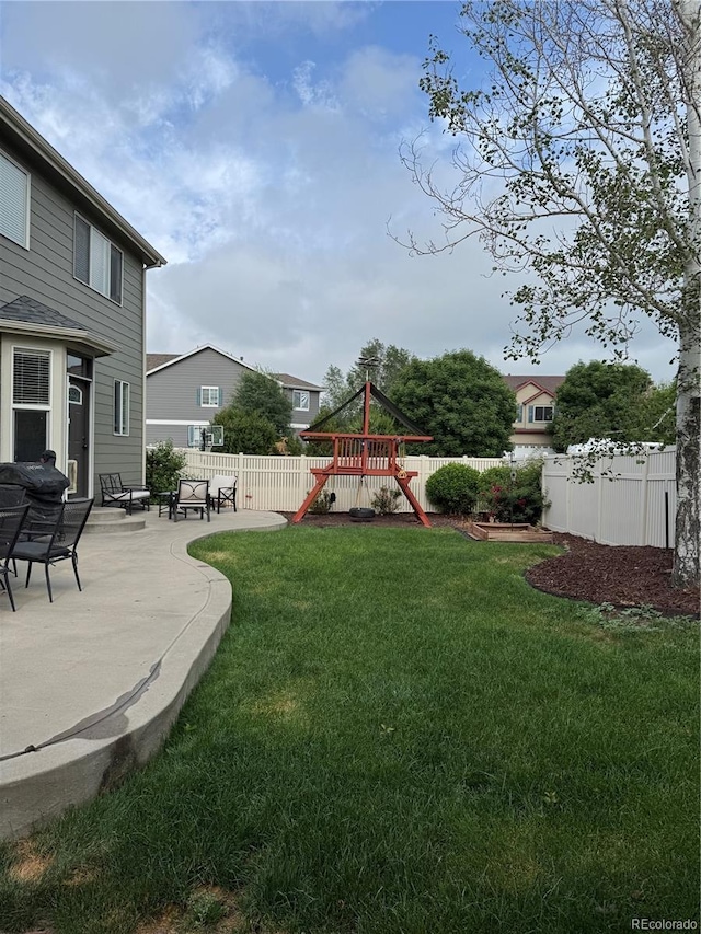 5861 Mt Shadows Blvd, Firestone, CO 80504 - fenced backyard featuring a playground and a patio