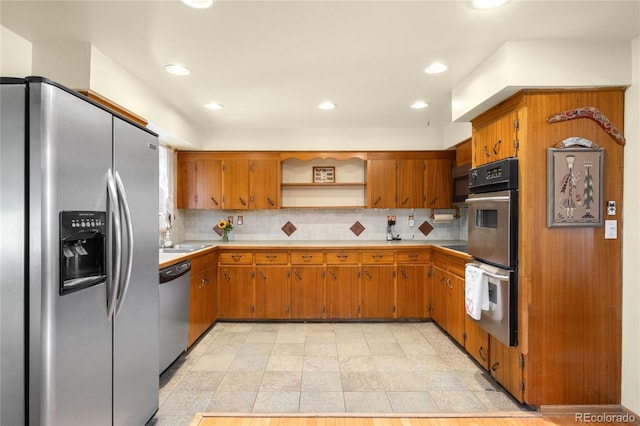 9045 W Ithaca Pl, Denver, CO 80235 - kitchen with appliances with stainless steel finishes, open shelves, light countertops, brown cabinetry, and recessed lighting