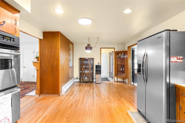 9045 W Ithaca Pl, Denver, CO 80235 - kitchen with appliances with stainless steel finishes, light wood-style flooring, brown cabinets, a baseboard heating unit, and recessed lighting