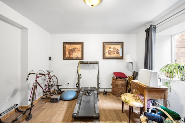 9045 W Ithaca Pl, Denver, CO 80235 - exercise room with wood finished floors, baseboards, and baseboard heating