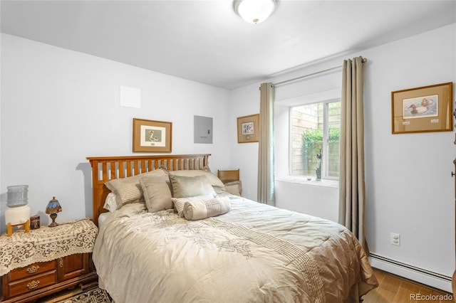 9045 W Ithaca Pl, Denver, CO 80235 - bedroom with a baseboard heating unit, wood finished floors, and electric panel