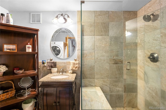 9045 W Ithaca Pl, Denver, CO 80235 - bathroom featuring a stall shower, vanity, and tile walls