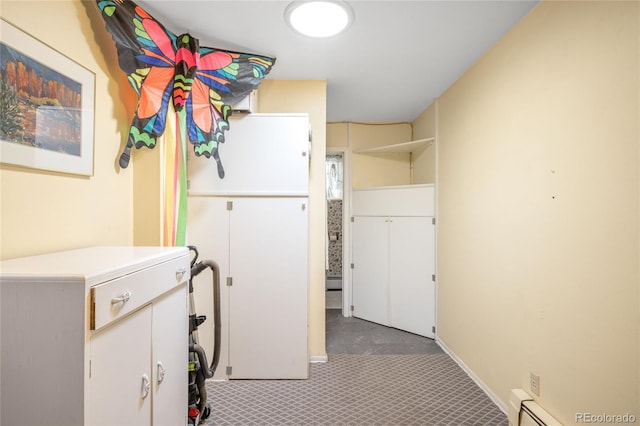 9045 W Ithaca Pl, Denver, CO 80235 - washroom with carpet floors, baseboard heating, and a baseboard radiator