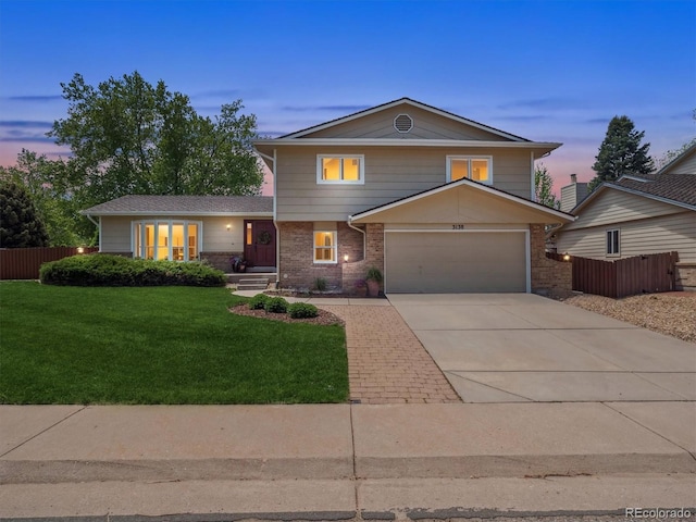 view of front of home with a garage, driveway, and brick siding