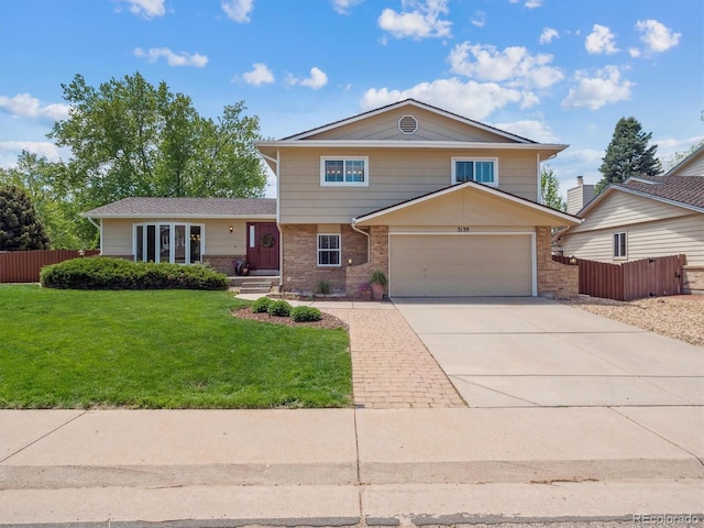 tri-level home with brick siding, concrete driveway, and a garage