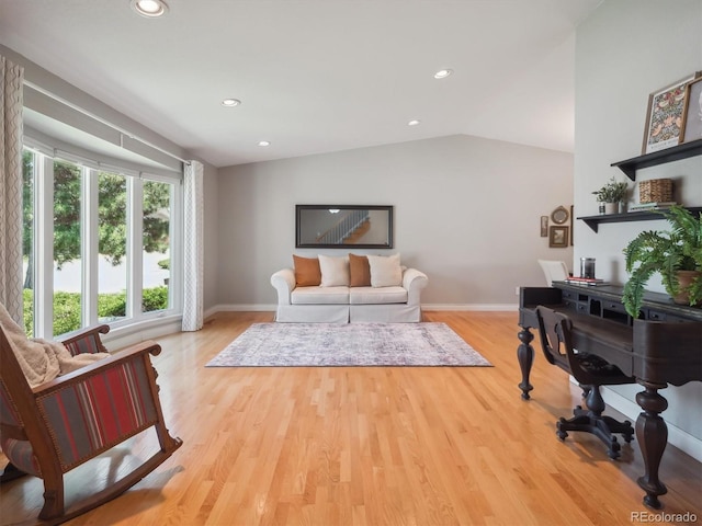 living room with light wood-style floors, baseboards, recessed lighting, and vaulted ceiling