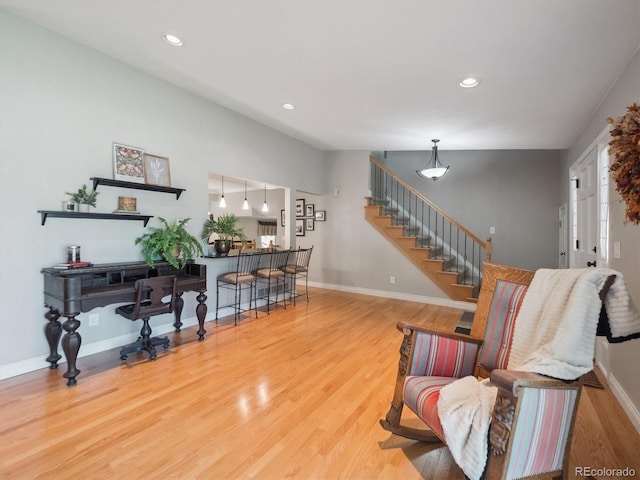 living area featuring stairway, wood finished floors, recessed lighting, and baseboards
