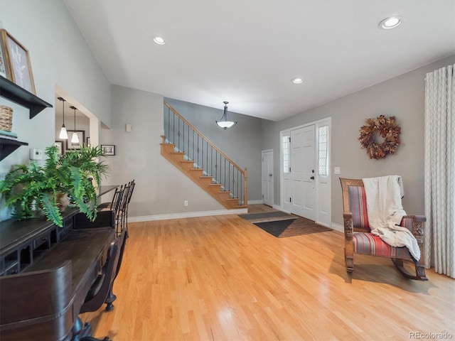 foyer with stairway, wood finished floors, recessed lighting, and baseboards