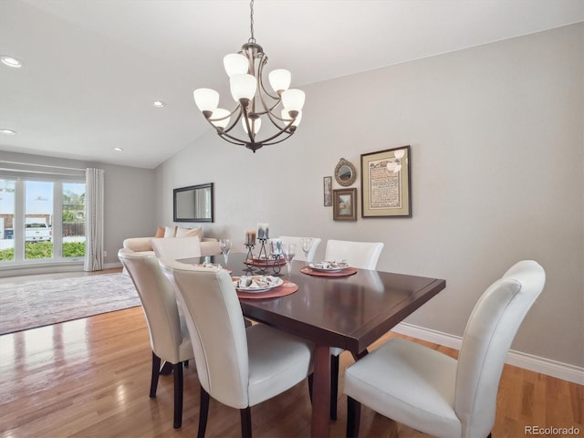 dining area featuring a chandelier, light wood-style flooring, baseboards, lofted ceiling, and recessed lighting