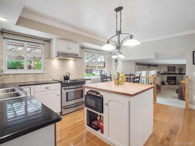 kitchen with stainless steel electric range oven, black microwave, wooden counters, white cabinetry, and crown molding