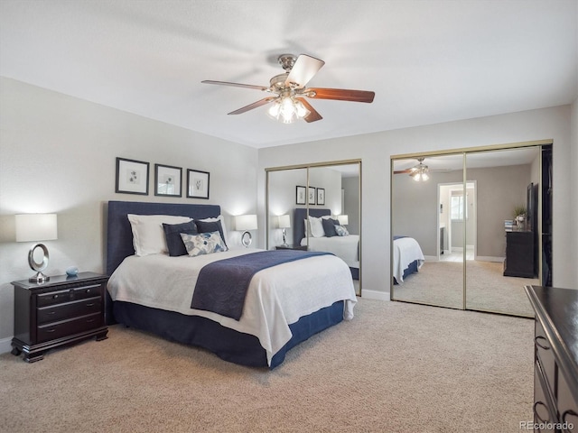 bedroom featuring two closets, carpet floors, a ceiling fan, and baseboards