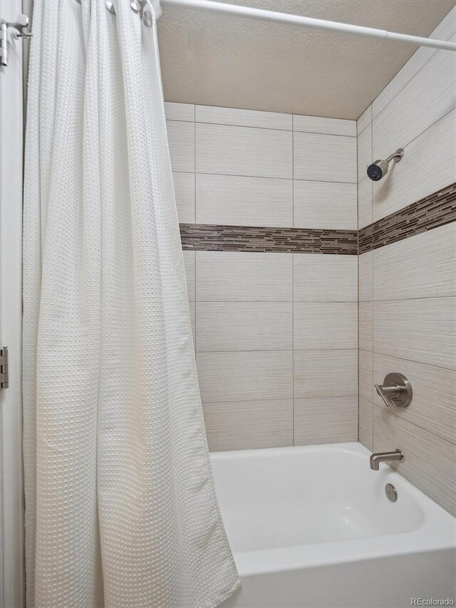 bathroom with shower / bathtub combination with curtain