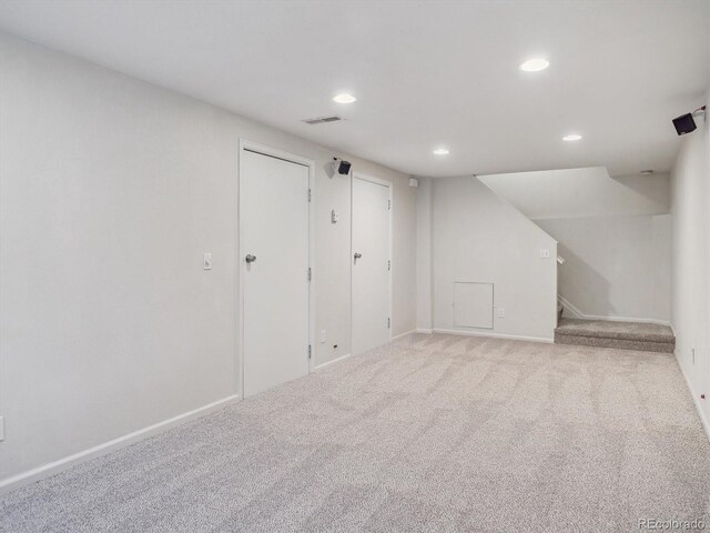 finished basement featuring recessed lighting, stairway, carpet, and baseboards