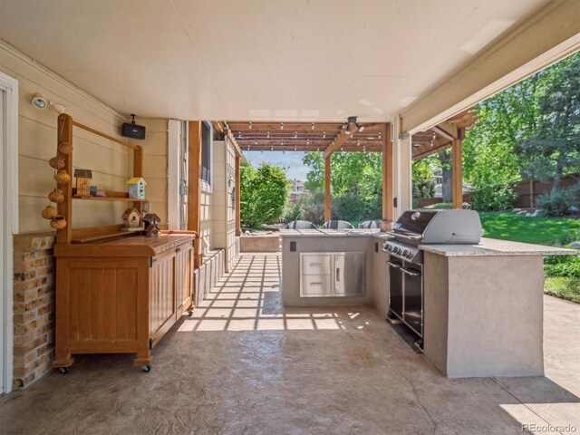 view of patio with exterior kitchen, grilling area, and fence