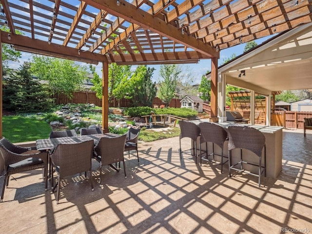 view of patio with a fenced backyard, outdoor dining area, and a pergola