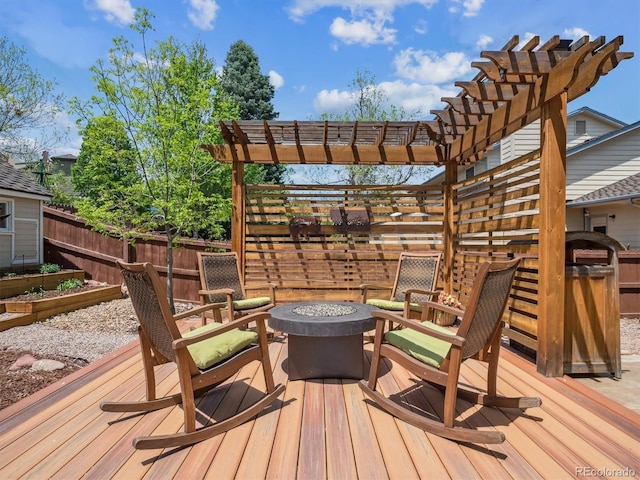 deck featuring a fire pit, fence, a pergola, and a vegetable garden