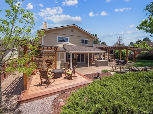 rear view of house with a pergola, a deck, a fenced backyard, and a chimney