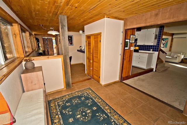 hallway featuring light tile patterned floors, wooden ceiling, and a wall unit AC