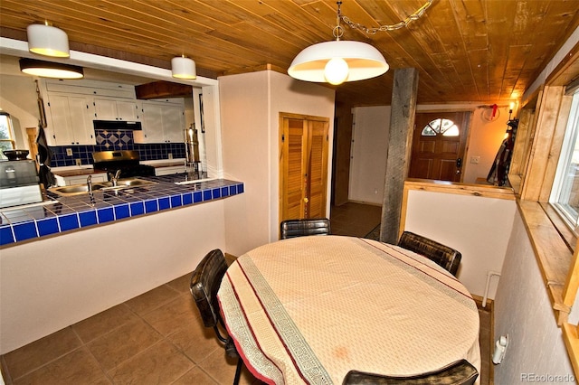 tiled dining area with wood ceiling