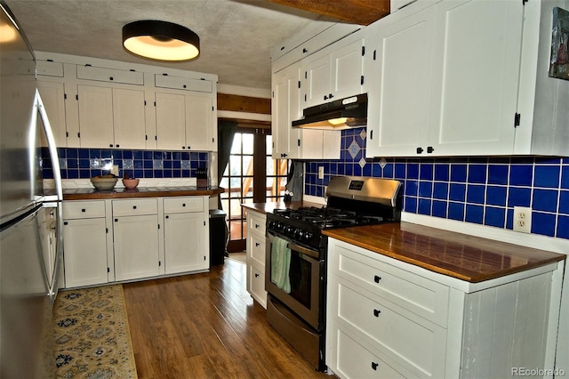 kitchen with tasteful backsplash, stainless steel appliances, dark wood-type flooring, white cabinetry, and butcher block counters