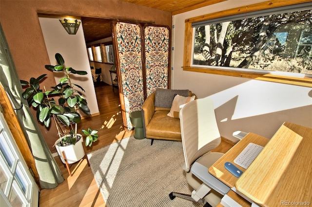 office space featuring lofted ceiling, hardwood / wood-style flooring, and wooden ceiling