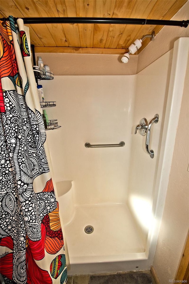 bathroom with curtained shower and wood ceiling